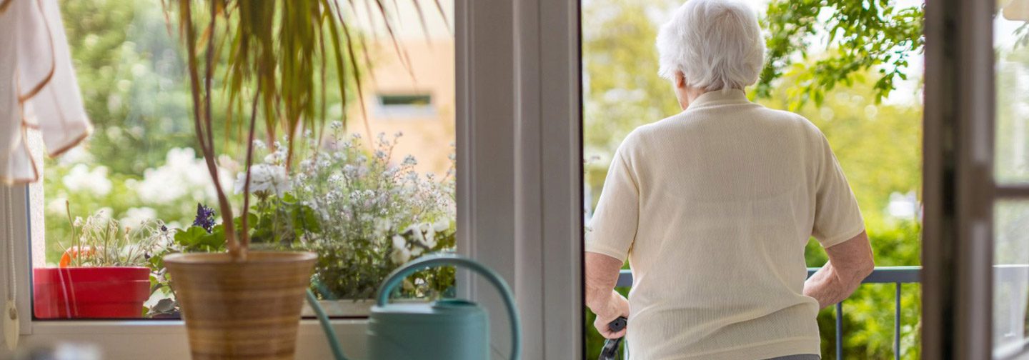 Woman stepping outside safely while living at home aging